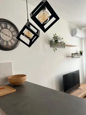 a clock on a wall next to a table at Delete 8 in Novi Grad
