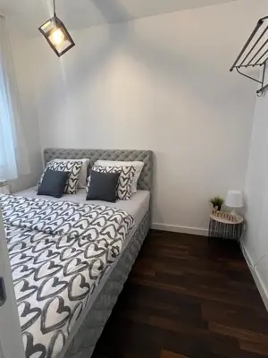 a bedroom with a couch with pillows on it at Delete 8 in Novi Grad