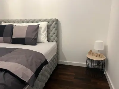 a bedroom with a bed and a table with a lamp at Delete 8 in Novi Grad
