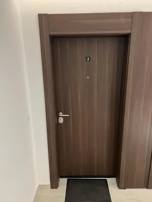 a wooden door in a room with a black rug at Delete 8 in Novi Grad
