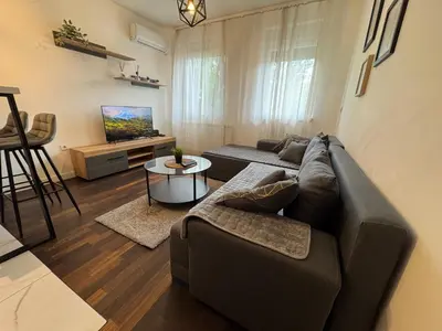 a living room with a couch and a table at Delete 8 in Novi Grad