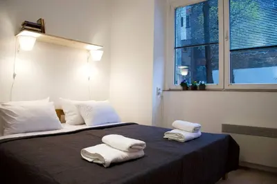 a bedroom with two towels on a bed with a window at ATELIER 12, Feeling like an artist! PROMO PRICE in Belgrade