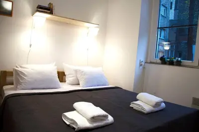 a bedroom with a bed with two towels on it at ATELIER 12, Feeling like an artist! PROMO PRICE in Belgrade