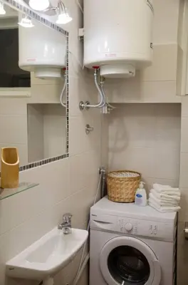 a bathroom with a washing machine and a sink at ATELIER 12, Feeling like an artist! PROMO PRICE in Belgrade