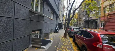 a red car parked on a street next to a building at ATELIER 12, Feeling like an artist! PROMO PRICE in Belgrade