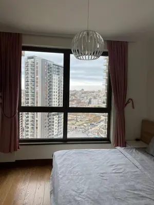 a bedroom with a large window with a chandelier at Belgrade Waterfront Premium in Belgrade