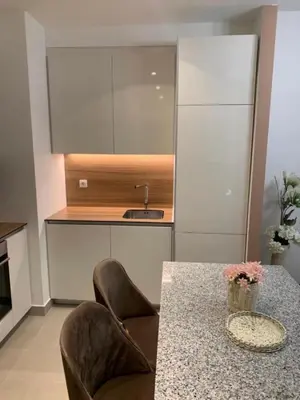 a kitchen with two chairs and a table and a sink at Belgrade Waterfront Premium in Belgrade