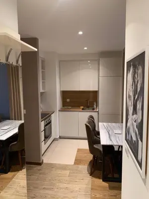 a kitchen and dining room with a table and chairs at Belgrade Waterfront Premium in Belgrade
