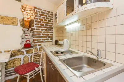 a kitchen with a sink and a brick wall at Hidden Gem on Prime Location in Belgrade