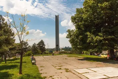 a person riding a bike in front of a monument at Hidden Gem on Prime Location in Belgrade
