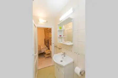 a white bathroom with a sink and a mirror at Hidden Gem on Prime Location in Belgrade