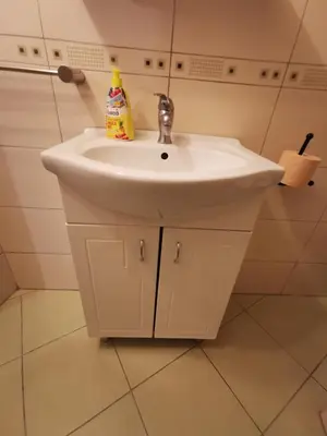 a white bathroom sink with a bottle of detergent on it at Hidden Gem on Prime Location in Belgrade