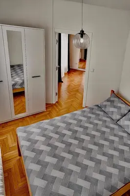 a bedroom with a bed with a gray comforter at Marina2 in Belgrade