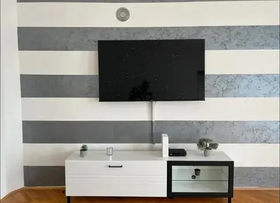 a living room with a white cabinet and a tv on a wall at Marina2 in Belgrade