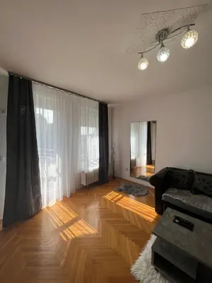 a living room with a couch and a wooden floor at Marina2 in Belgrade