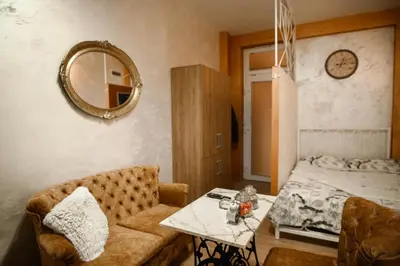 a room with a couch and a table and a bed at Stan11550 Centar in Lazarevac