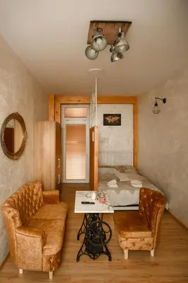 a room with a bed and a couch and a table at Stan11550 Centar in Lazarevac