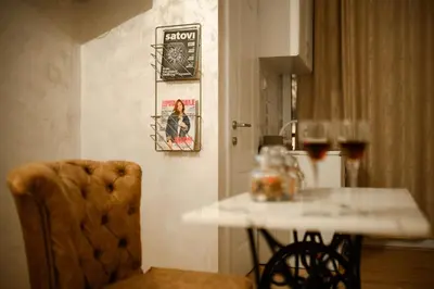 a dining room with a table and a table and a chair at Stan11550 Centar in Lazarevac