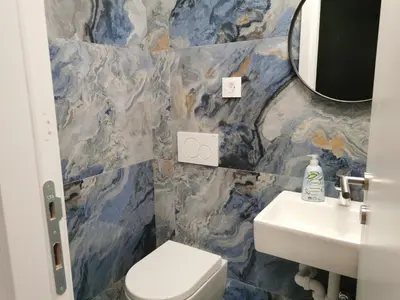 a bathroom with a sink and a toilet and a mirror at BG Exclusive Suites in Belgrade