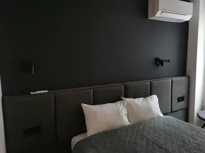 a bedroom with a bed with white pillows at BG Exclusive Suites in Belgrade