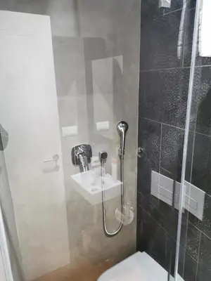 a bathroom with a shower and a toilet and a sink at BG Exclusive Suites in Belgrade