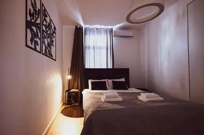 a bedroom with a bed with two towels on it at BG Exclusive Suites in Belgrade