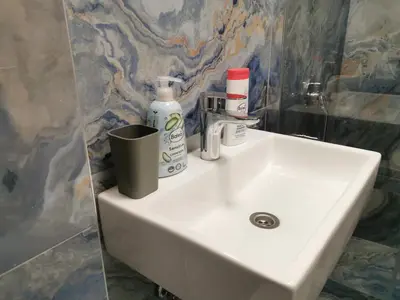 a bathroom sink with toiletries on top of it at BG Exclusive Suites in Belgrade