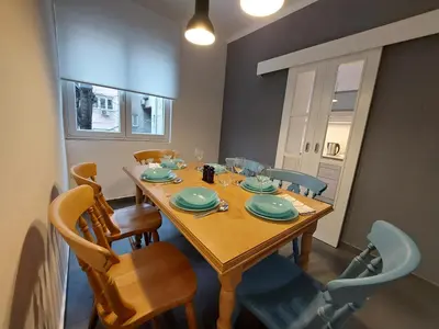 a dining room with a wooden table and chairs at Dalmatinska apartment in Belgrade