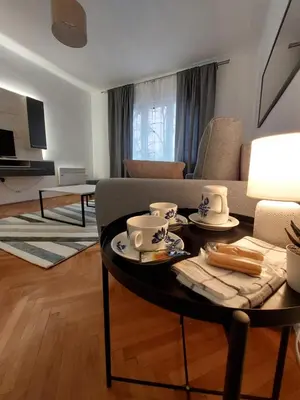 a living room with a table and a couch at Dalmatinska apartment in Belgrade