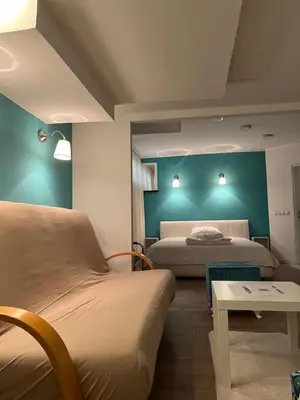 two beds in a room with blue walls at Apartman Dunja S in Belgrade