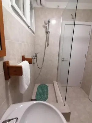a bathroom with a shower and a white tub at Apartman Dunja S in Belgrade
