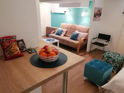 a living room with a bowl of fruit on a table at Apartman Dunja S in Belgrade