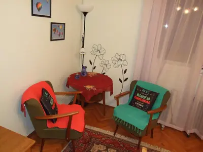 a living room with chairs and a table and a table at Georgina in Rospi Ćuprija