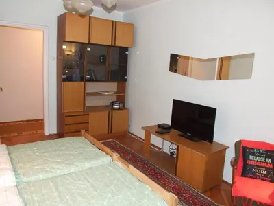a living room with a bed and a flat screen tv at Georgina in Rospi Ćuprija