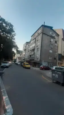a city street with cars parked in front of buildings at Georgina in Rospi Ćuprija