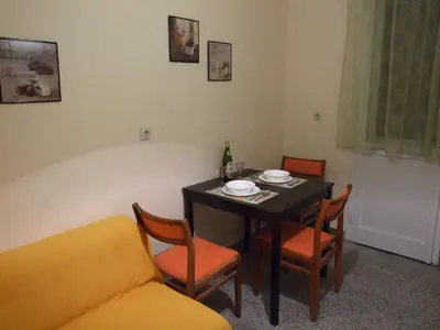 a living room with a table and chairs and a couch at Georgina in Rospi Ćuprija