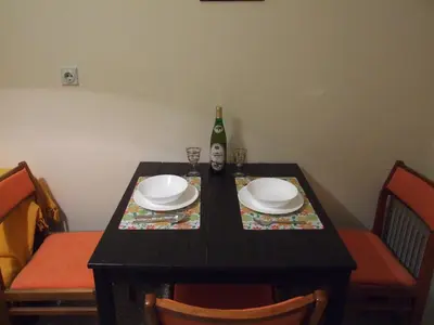 a black table with plates and a bottle of wine at Georgina in Rospi Ćuprija