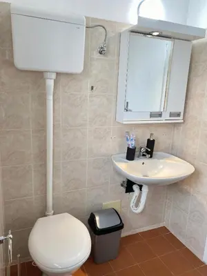 a bathroom with a white toilet and a sink at Panorama Royal Vračar in Vračar (historical)