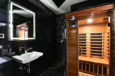 a black bathroom with a sink and a shower at Lux Spa Apartman na Vračaru in Vračar (historical)