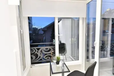 a large window with a view of a balcony at Lux Spa Apartman na Vračaru in Vračar (historical)