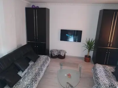 a living room with a couch and a glass table at Apartman Hrkalovic in Arandjelovac