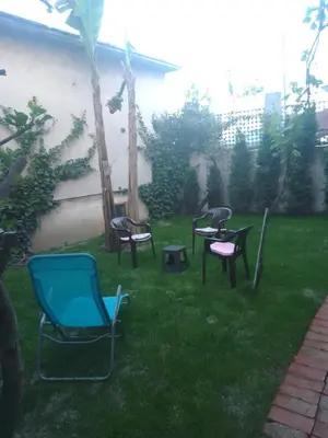 a group of chairs sitting in the grass at Apartman Hrkalovic in Arandjelovac