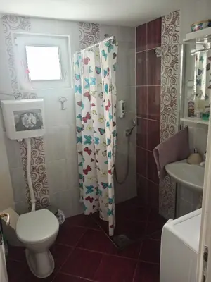 a bathroom with a toilet and a sink at Apartman Hrkalovic in Arandjelovac