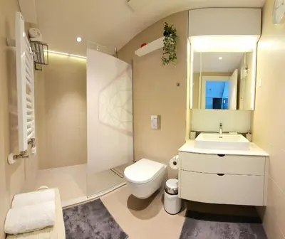 a bathroom with a toilet and a sink and a mirror at Belgrade Waterfront 10th fl Lux Apt. w/ City view in Belgrade