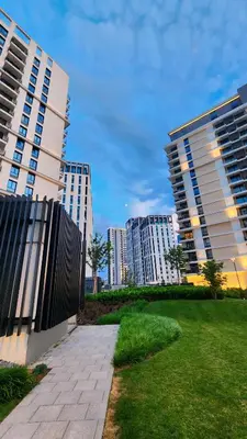 two tall buildings in a city with a park at Belgrade Waterfront 10th fl Lux Apt. w/ City view in Belgrade