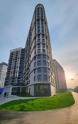 a tall building with a green lawn in front of it at Belgrade Waterfront 10th fl Lux Apt. w/ City view in Belgrade