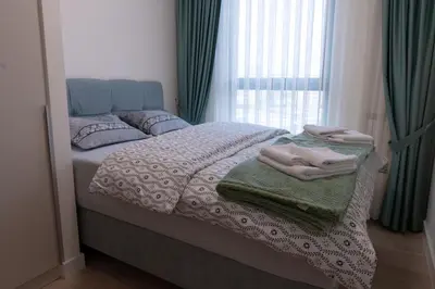 a bedroom with a bed with blankets and a window at Tommy BW in Belgrade