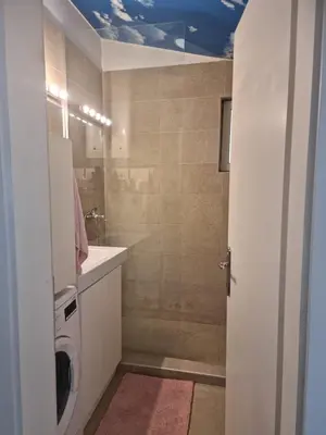 a bathroom with a sink and a washing machine at HEART OF BELGRADE cozy LUX APARTMENT in Belgrade
