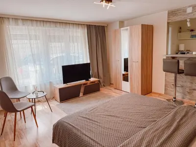a bedroom with a bed and a flat screen tv at Mateja Apartman in Belgrade