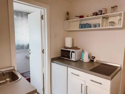 a small kitchen with a microwave and a sink at Mateja Apartman in Belgrade